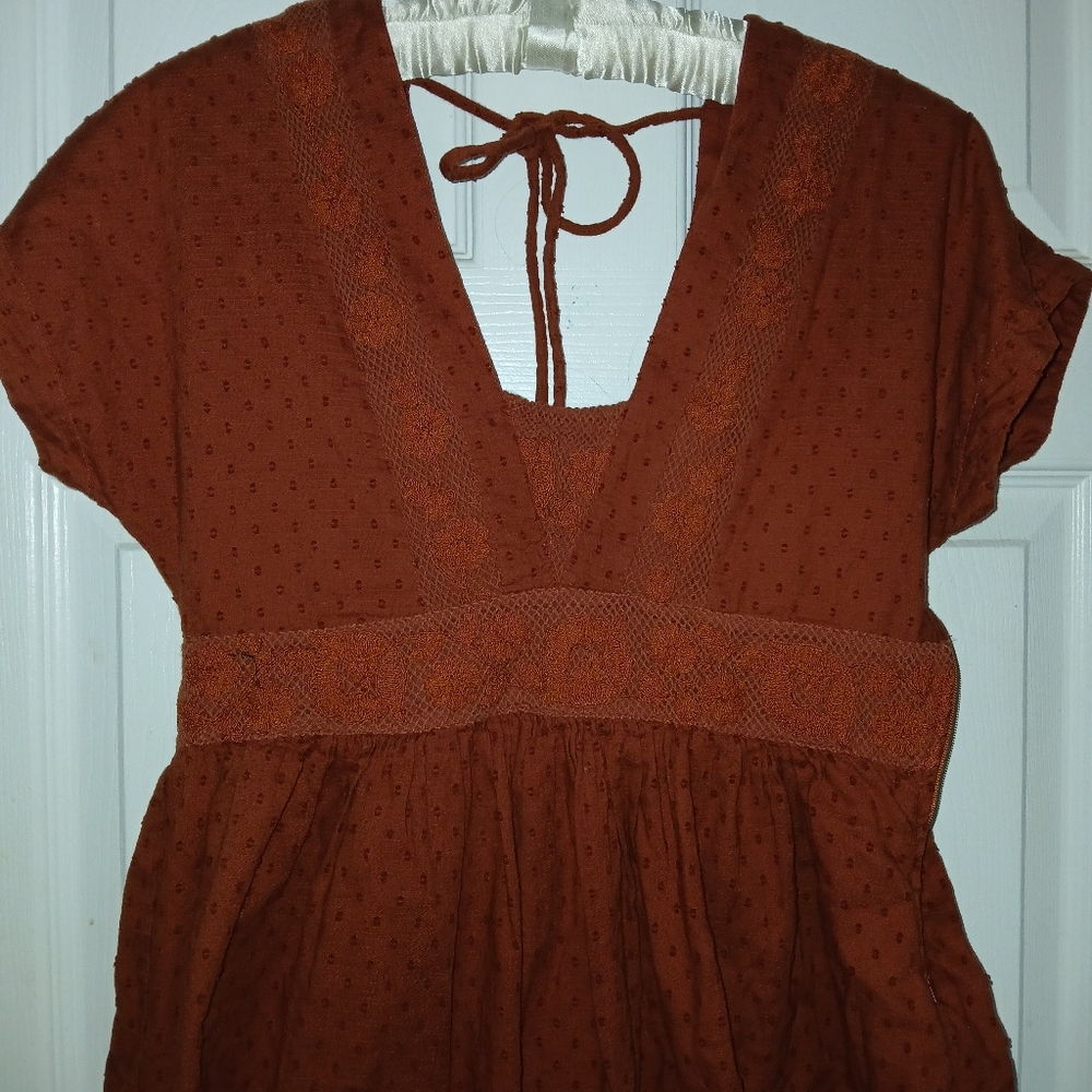 1970's inspired burnt orange babydoll lace tie back dress